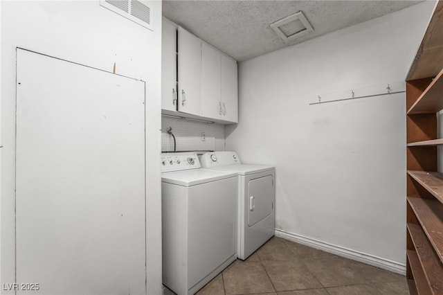 laundry room with cabinet space, separate washer and dryer, attic access, light tile patterned flooring, and baseboards