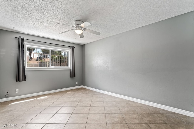 unfurnished room featuring ceiling fan, a textured ceiling, baseboards, and tile patterned flooring
