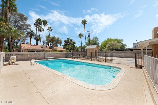 view of swimming pool featuring a patio area, fence, and a diving board
