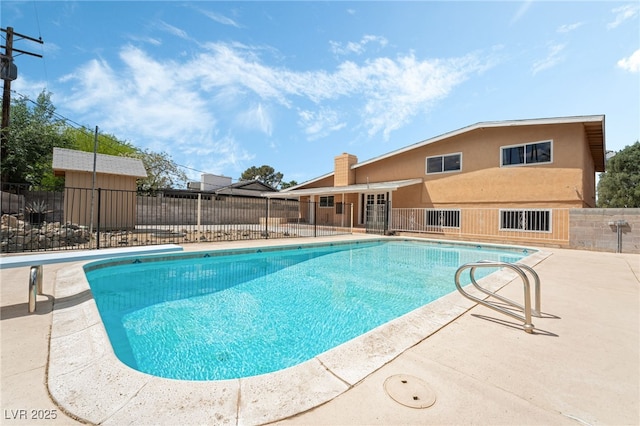 view of pool featuring fence and a patio