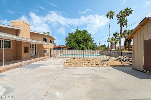 view of swimming pool with a patio and fence