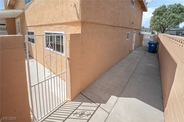 view of property exterior featuring fence and stucco siding