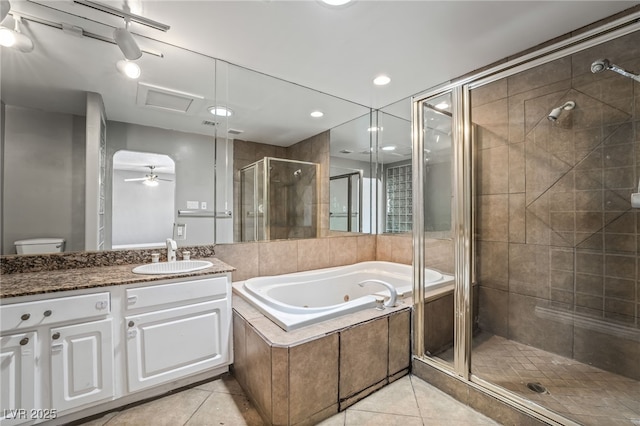 bathroom featuring tile patterned floors, a shower stall, a tub with jets, and vanity