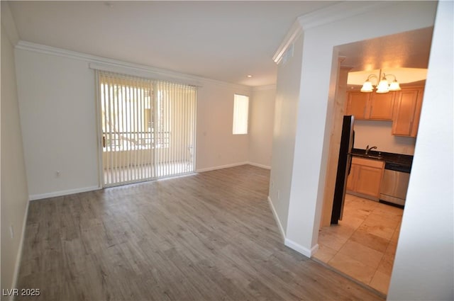 270 E Flamingo Rd Unit 136, Las Vegas, NV 89169 - unfurnished room featuring crown molding, a chandelier, light wood-style flooring, and baseboards