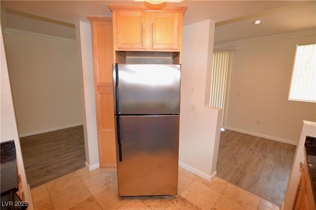 270 E Flamingo Rd Unit 136, Las Vegas, NV 89169 - kitchen with freestanding refrigerator, light brown cabinetry, crown molding, baseboards, and recessed lighting