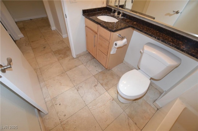 270 E Flamingo Rd Unit 136, Las Vegas, NV 89169 - bathroom featuring toilet, vanity, and baseboards
