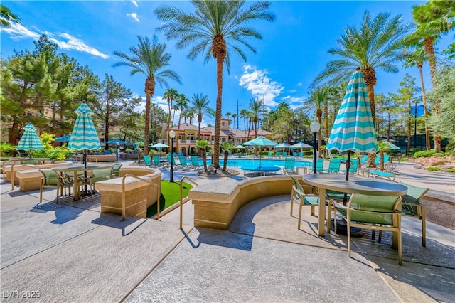 270 E Flamingo Rd Unit 136, Las Vegas, NV 89169 - view of patio / terrace featuring a community pool and outdoor dining space