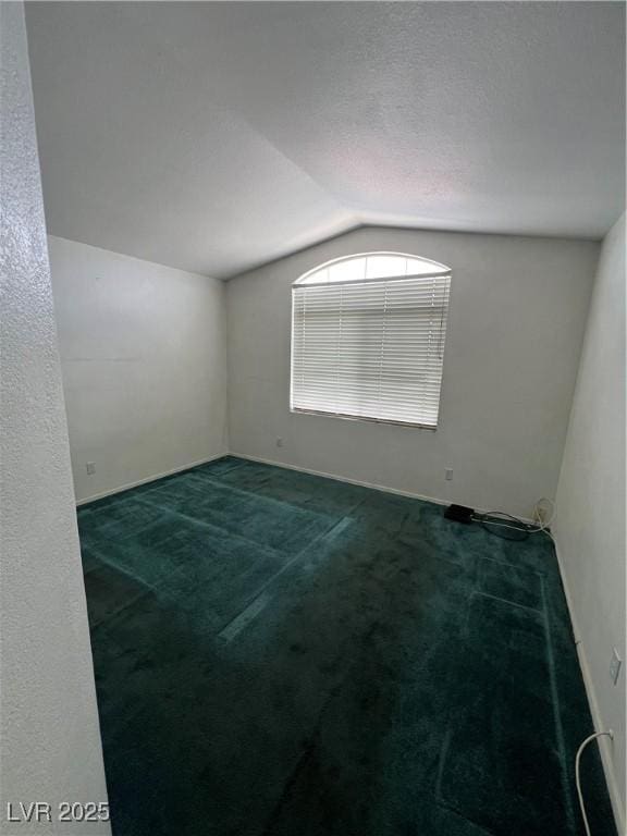 128 Appian Way, Henderson, NV 89002 - unfurnished room with vaulted ceiling, carpet floors, and baseboards