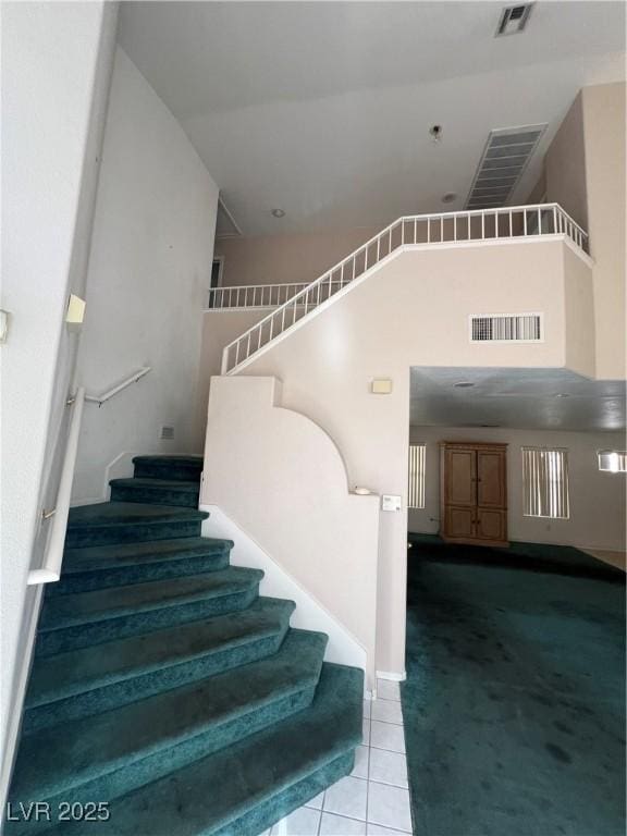 128 Appian Way, Henderson, NV 89002 - stairs featuring carpet, tile patterned floors, a high ceiling, and baseboards