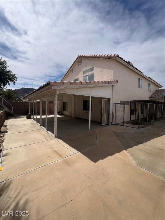 128 Appian Way, Henderson, NV 89002 - view of side of home featuring fence, stucco siding, and a tile roof
