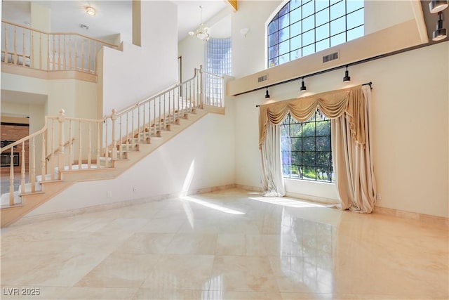 1931 Pago Ct, Las Vegas, NV 89117 - entryway featuring a high ceiling, stairway, and a chandelier