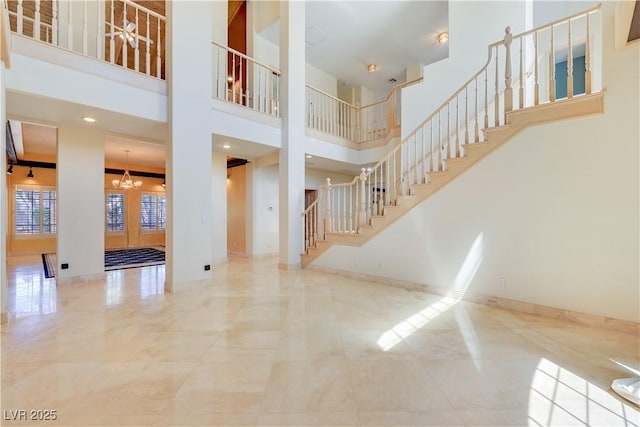 1931 Pago Ct, Las Vegas, NV 89117 - entrance foyer with stairs, a chandelier, and a high ceiling