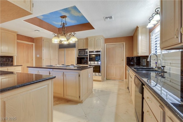 1931 Pago Ct, Las Vegas, NV 89117 - kitchen featuring appliances with stainless steel finishes, decorative backsplash, a center island, decorative light fixtures, and light brown cabinetry