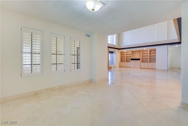 1931 Pago Ct, Las Vegas, NV 89117 - unfurnished room with a towering ceiling and baseboards
