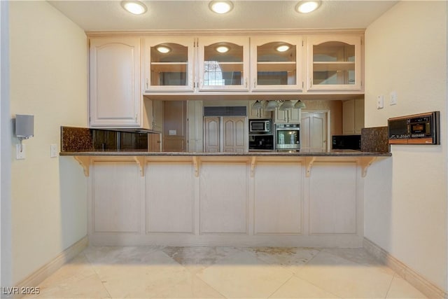 1931 Pago Ct, Las Vegas, NV 89117 - kitchen with built in appliances, a breakfast bar area, and glass insert cabinets