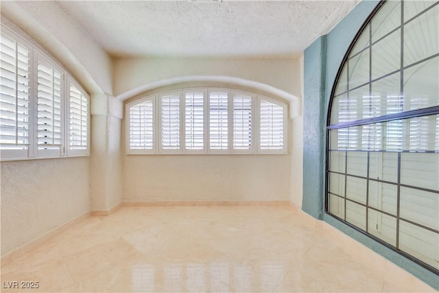 1931 Pago Ct, Las Vegas, NV 89117 - spare room with healthy amount of natural light and a textured ceiling