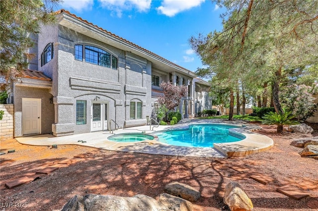 1931 Pago Ct, Las Vegas, NV 89117 - back of house featuring a tile roof, a patio, stucco siding, an in-ground hot tub, and an outdoor pool