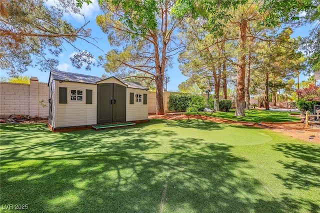 1931 Pago Ct, Las Vegas, NV 89117 - fenced backyard with a storage unit and an area to practice putting
