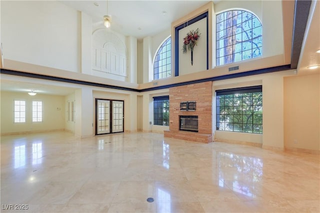 1931 Pago Ct, Las Vegas, NV 89117 - unfurnished living room featuring a high ceiling, marble tiled flooring, and a large fireplace