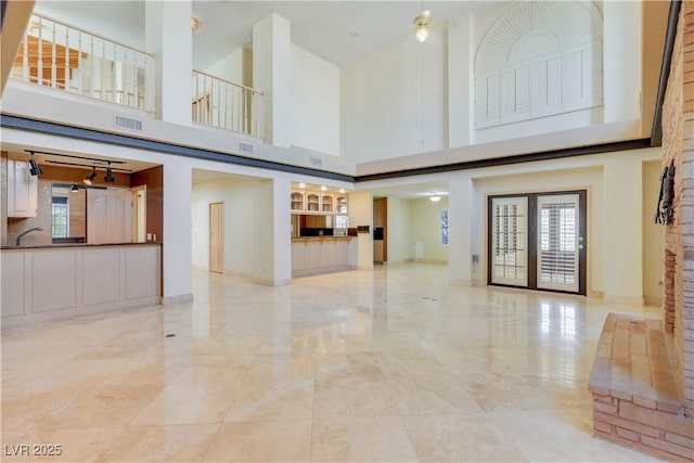 1931 Pago Ct, Las Vegas, NV 89117 - unfurnished living room with a towering ceiling and light marble finish flooring