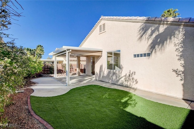 rear view of property featuring a patio area and stucco siding