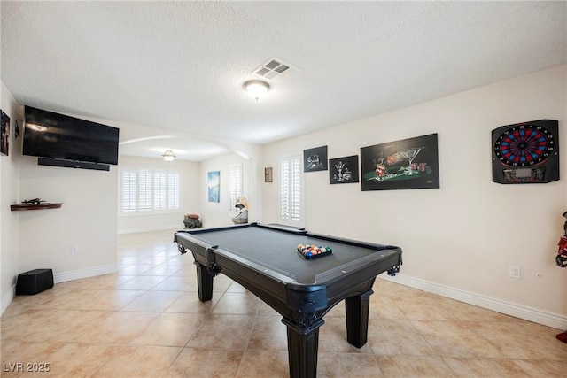 playroom with arched walkways, baseboards, a textured ceiling, billiards table, and light tile patterned floors