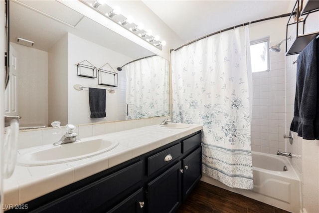 bathroom featuring shower / bath combo, wood finished floors, and double vanity