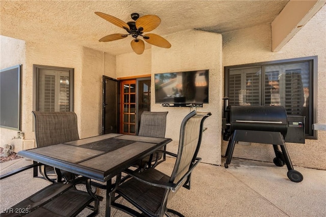 view of patio featuring outdoor dining space and a ceiling fan