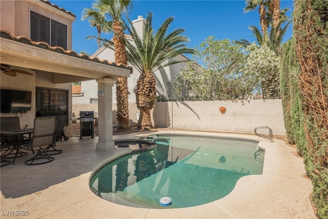 view of pool with a fenced backyard, a patio, a ceiling fan, and grilling area