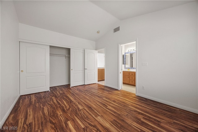 5148 Forest Oaks Dr, Las Vegas, NV 89149 - unfurnished bedroom featuring lofted ceiling, wood finished floors, a closet, baseboards, and ensuite bathroom