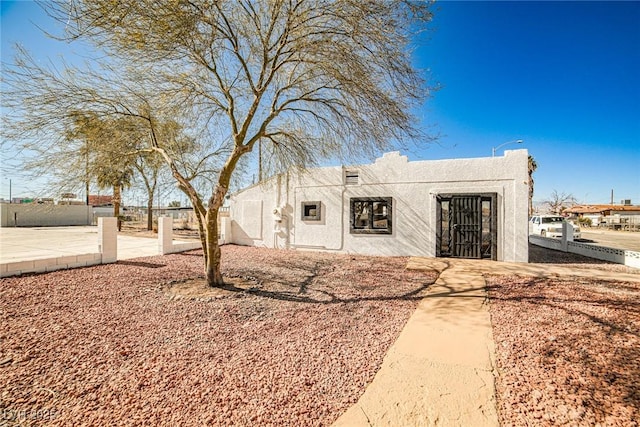 603 W Adams Ave, Las Vegas, NV 89106 - view of front of home with stucco siding and fence