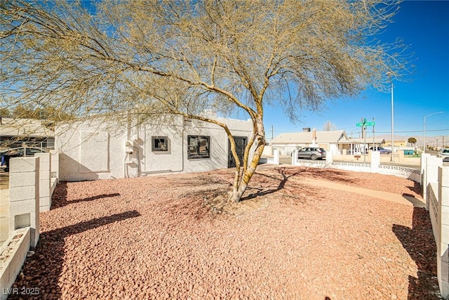 603 W Adams Ave, Las Vegas, NV 89106 - view of front facade with fence and stucco siding