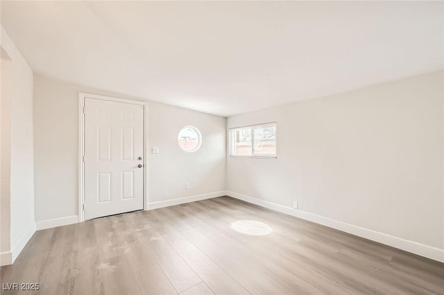 foyer entrance featuring wood finished floors and baseboards