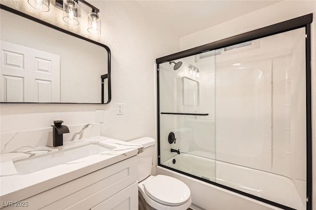 full bathroom featuring toilet, vanity, and combined bath / shower with glass door