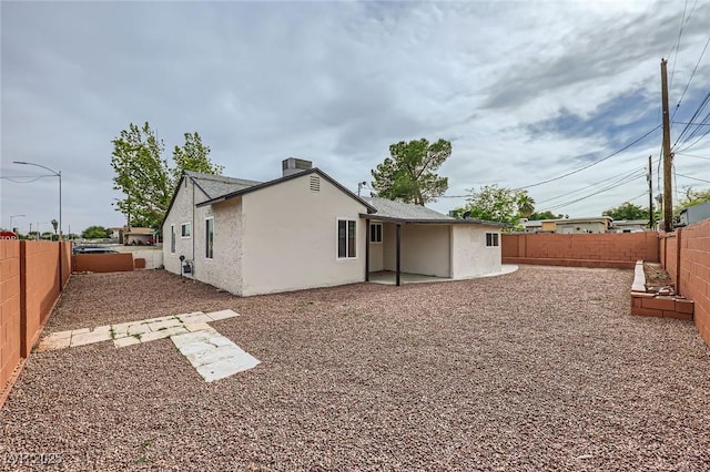 rear view of property with a fenced backyard