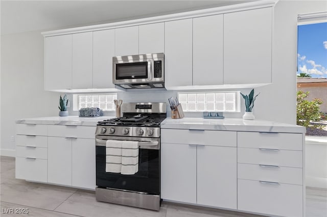 2029 Poppywood Ave, Henderson, NV 89012 - kitchen featuring appliances with stainless steel finishes, modern cabinets, white cabinetry, and tasteful backsplash