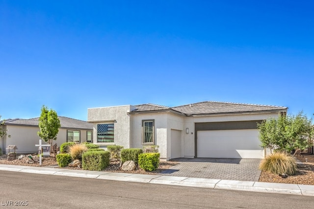 4893 E Cedar Creek Way, Pahrump, NV 89061 - view of front of property featuring a garage, stucco siding, and driveway