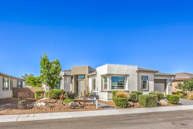 4893 E Cedar Creek Way, Pahrump, NV 89061 - view of front of house with a garage and stucco siding