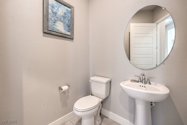 4893 E Cedar Creek Way, Pahrump, NV 89061 - half bathroom with baseboards, toilet, and a sink