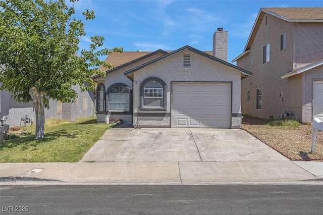 1622 Lorna Dr, Henderson, NV 89011 - view of front facade featuring an attached garage, a chimney, driveway, and a front yard
