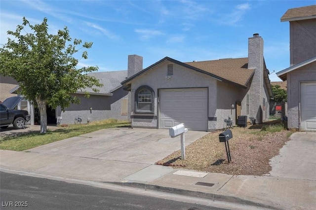 1622 Lorna Dr, Henderson, NV 89011 - single story home featuring an attached garage, central AC unit, concrete driveway, a chimney, and stucco siding