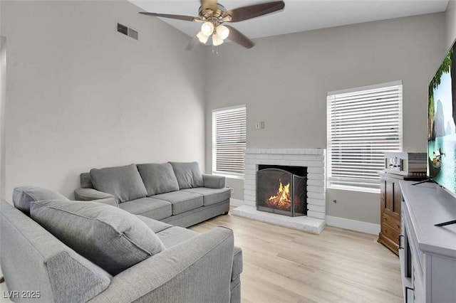 1622 Lorna Dr, Henderson, NV 89011 - living room with a ceiling fan, light wood-type flooring, a fireplace, and baseboards