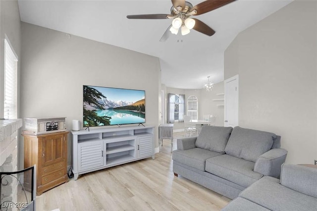 1622 Lorna Dr, Henderson, NV 89011 - living room with light wood-type flooring, ceiling fan, vaulted ceiling, and a chandelier