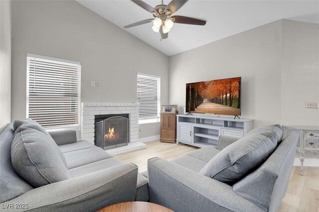1622 Lorna Dr, Henderson, NV 89011 - living room with wood finished floors, ceiling fan, high vaulted ceiling, a brick fireplace, and baseboards