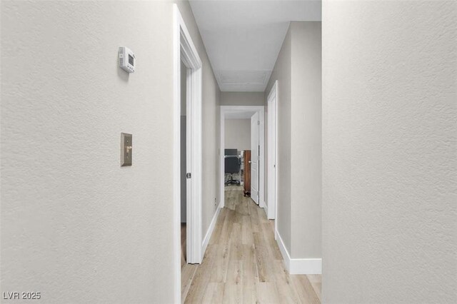1622 Lorna Dr, Henderson, NV 89011 - corridor featuring attic access, a textured wall, light wood-type flooring, and baseboards