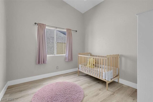 1622 Lorna Dr, Henderson, NV 89011 - bedroom with wood finished floors, baseboards, high vaulted ceiling, and a nursery area