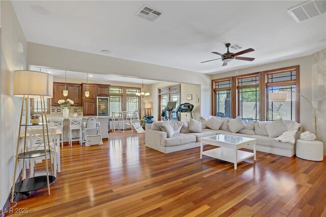 10520 Maystar Ln, Las Vegas, NV 89135 - living room featuring wood finished floors, ceiling fan, and a chandelier