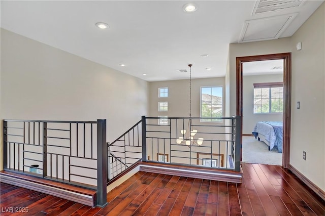 staircase with wood finished floors, healthy amount of natural light, baseboards, and recessed lighting