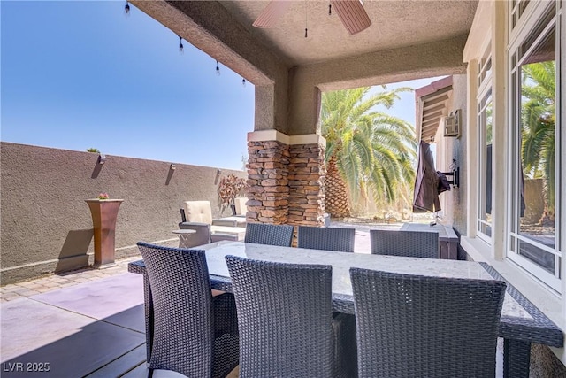 view of patio / terrace featuring a ceiling fan and outdoor dining space