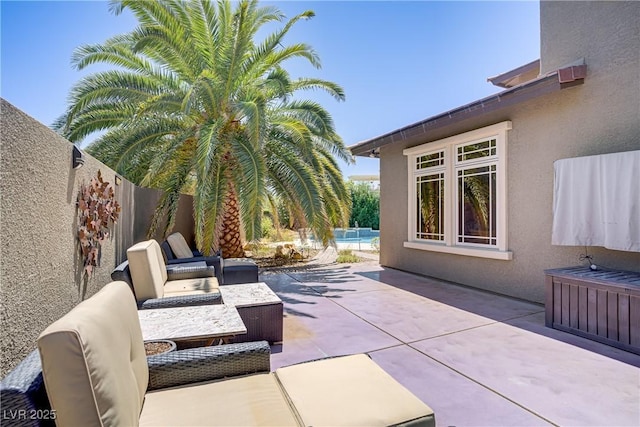 view of patio with outdoor lounge area and fence